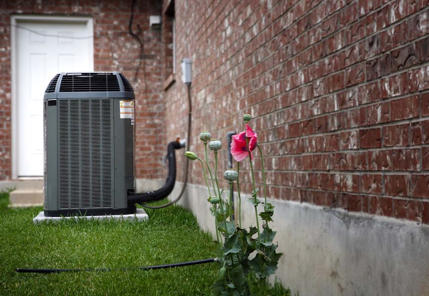 Air conditioner in backyard of home