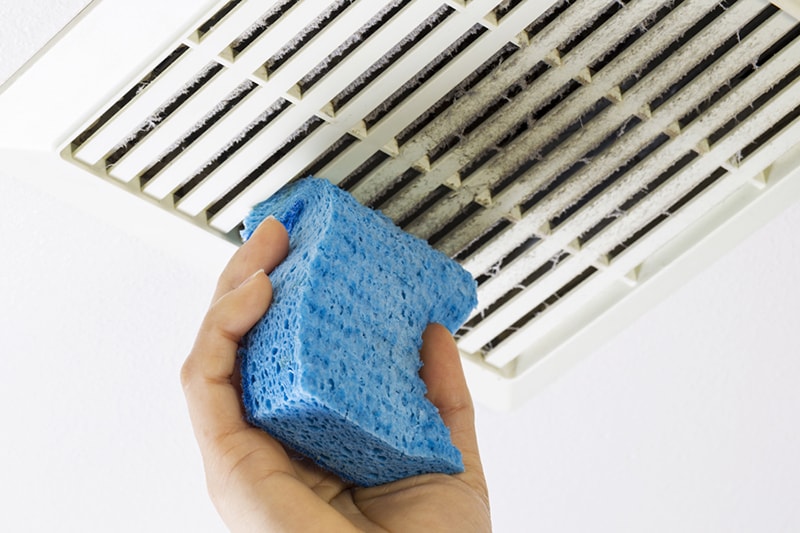 blue sponge cleaning dirty air duct