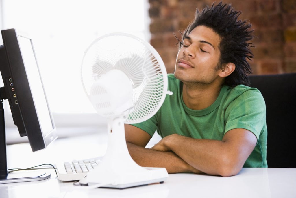 Man in front of a fan because he needs new air conditioning in Tomahawk
